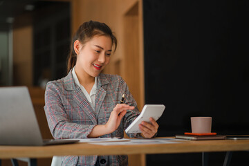 Asian business woman working on laptop computer in her workstation, startup, businessperson, employee, marketing concept, account, online finance, ecommerce, freelance.