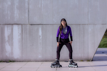 young sporty woman practicing inline skating in an urban setting