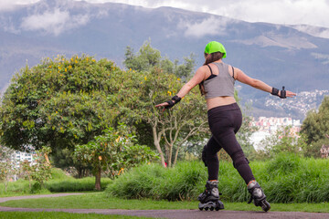 young sporty woman practicing inline skating in an urban setting