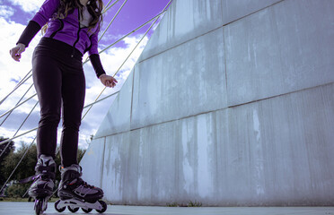 young sporty woman practicing inline skating in an urban setting