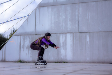 young sporty woman practicing inline skating in an urban setting