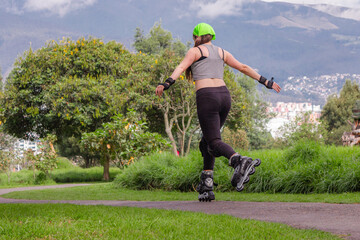 young sporty woman practicing inline skating in an urban setting