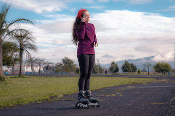 young sporty woman practicing inline skating in an urban setting. Prepare sportwatch and headphones