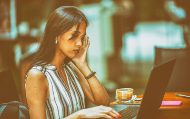 Asian business woman using laptop outdoor.