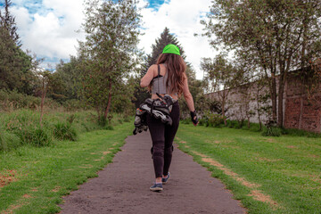 young sporty woman walking with line skates, ready to practice skating.
