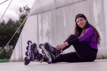 young sporty woman practicing inline skating in an urban setting