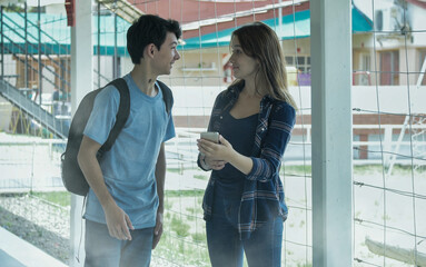Caucasian teenager couple talking at school