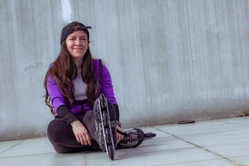 young sporty woman practicing inline skating in an urban setting