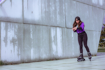 young sporty woman practicing inline skating in an urban setting