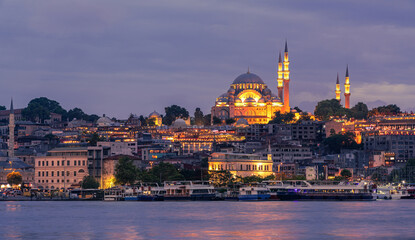 Fototapeta na wymiar Suleymaniye Mosque with night illumination and minaret of Rustem Pasha Mosque, Istanbul, Turkey