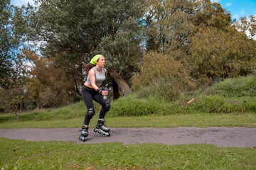 young sporty woman practicing inline skating in an urban setting. High quality photo