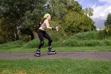 young sporty woman practicing inline skating in an urban setting. High quality photo