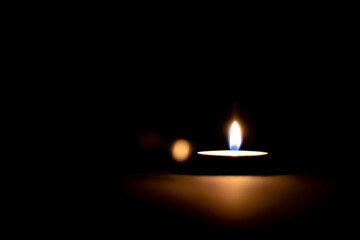 candle on flame at night on a black background