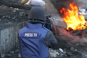 Journalist in protective helmet during Euromaidan im Kyiv, Ukraine on January 2014