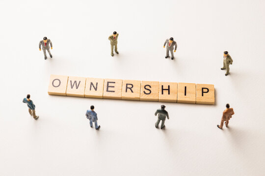 businessman figures at ownership words