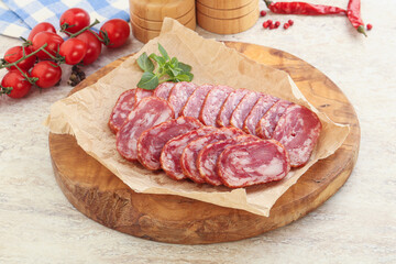 Sliced salami sausages over board