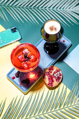 Ripe pomegranates with juice on table. Glass of pomegranate juice and fresh fruits on table.
