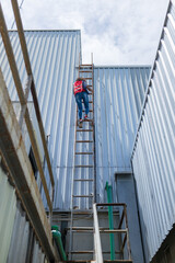 Engineering or worker descended the fire escape to the safe zone. Man in Fire escape to the roof....