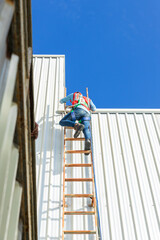 Engineering or worker descended the fire escape to the safe zone. Man in Fire escape to the roof. Worker climbing down fire escape ladder