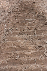 Wheel tracks on the soil. Tire in the sand or mud. Tire trace tracks car on a soil. Rural road in forest close up view. Off road dirty track