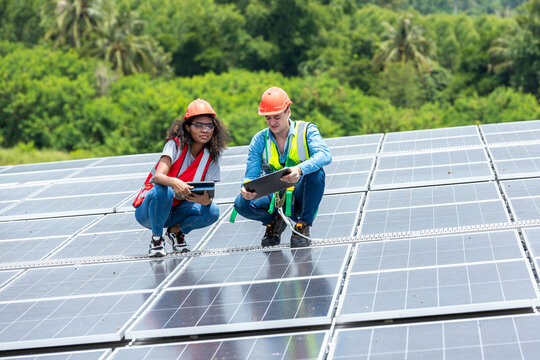 Engineer working setup Solar panel at the roof top. Engineer or worker work on solar panels or solar cells on the roof of business building