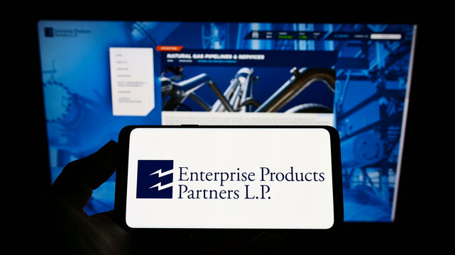 Stuttgart, Germany - 02-05-2022: Person holding cellphone with logo of pipeline company Enterprise Products Partners L.P. on screen in front of webpage. Focus on phone display.