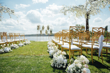 Premium arch for wedding ceremony for newlyweds on the river bank with wisteria trees