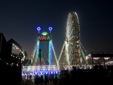 Giant Wheel Carnival Ride Or Ferris Wheel Flyer Ride In Indian Village Fair Ground At Night