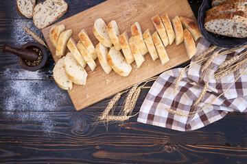 Fresh sliced bread on wooden cutting board at kitchen table