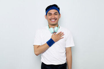 portrait of smiling young Asian sportman in blue headband and sportswear white t-shirt with...