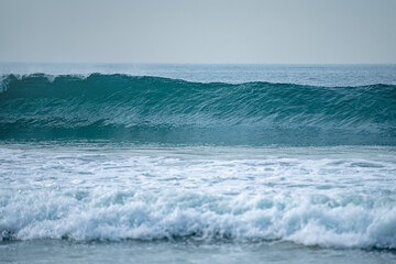 Sea foam. Ocean or sea tropical waves. Ocean background, seascape. Tropical beach with wave, nature background. Copy space of summer vacation and travel concept.