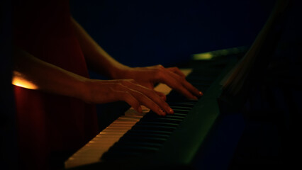 Fototapeta na wymiar the pianist plays the piano. female hands touching piano keys close-up
