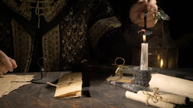 Sealing letters in ancient times.
18th century letter seal. Melting sealing wax by candlelight.
