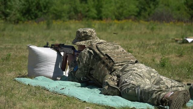 Ukrainian soldier loads machine gun magazine with cartridges