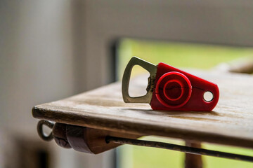 a bottle opener on a rustic table