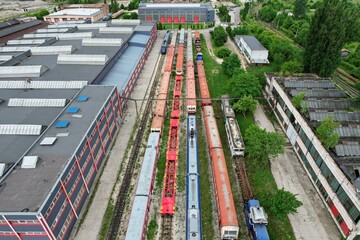 Aerial view above an industrial railroad yard with several trains on railroad tracks