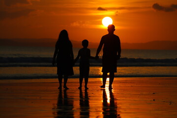 family in sunset at beach