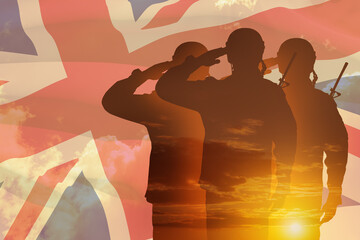 Silhouettes of soldiers with print of sunset saluting on a background of United Kingdom flag.