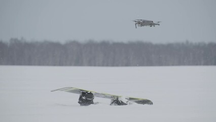 Search drone detects missing person snowboarder covered in snow, rescue operations.