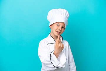 Little chef boy isolated on blue background doing coming gesture