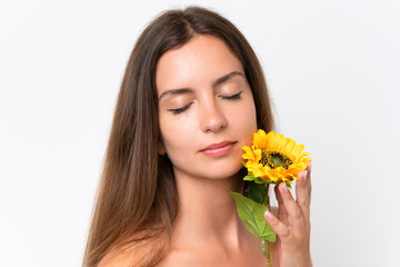 Young caucasian woman isolated on white background holding a sunflower. Close up portrait