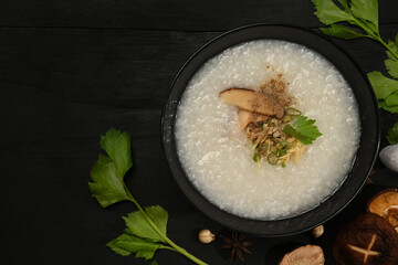 Rice porridge, rice gruel or congee with shiitake mushroom, slice ginger and scallion for breakfast...