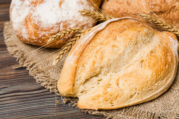 Homemade natural breads. Different kinds of fresh bread as background, perspective view with copy space