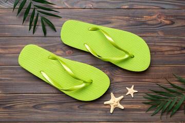 Flat lay composition with flip flops and seashell on colored background. Space for text top view