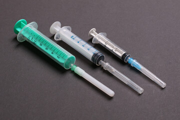 Top view of syringes in a row for medical injection on colorful background with copy space. Health and vaccination concept