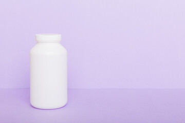 supplement pills with medicine bottle health care and medical top view. Vitamin tablets. Top view mockup bottle for pills and vitamins with green leaves, natural organic bio supplement, copy space