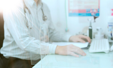 doctor sit and work on table in office