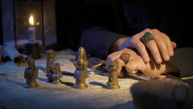 Historical ages background. Special embroidered rings on her finger. 18th century reenactment. Symbolic chess pieces on the map.