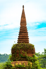 The top of the stone pagoda, the entrance to Khao Na Luang Tham National Park the background is a bright sky Nakhon Si Thammarat, Thailand, vertical photo.