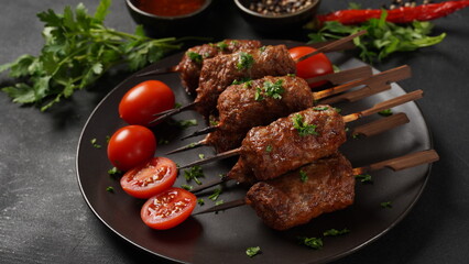 Shish kebab is a popular meal of skewered and grilled cubes of meat. Roasted Beef Kebab on a wooden...